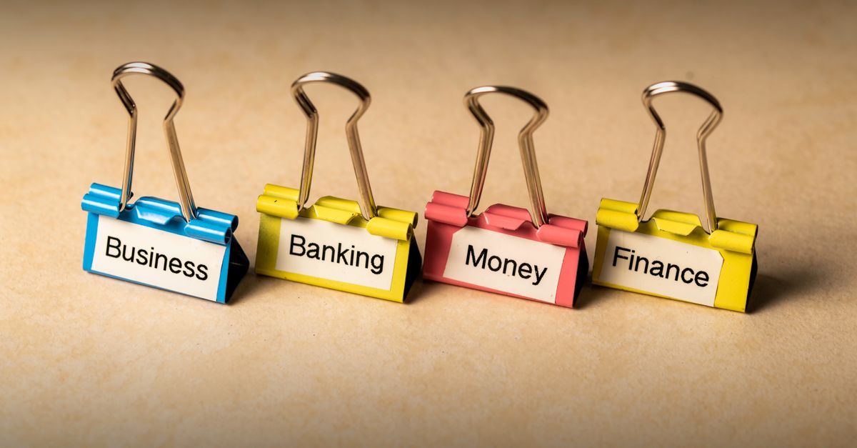 Close-up of binder clips with labels for business, banking, money, and finance concepts.